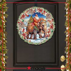 a christmas wreath with an elephant and santa clause on it