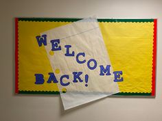 there is a welcome back sign on the wall next to two pieces of paper that say welcome back