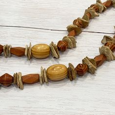 Wood Necklace, Tribal Wood Necklace, Wood Bead Necklace, Boho Wood Necklace, Unisex Wood Necklace, Wood Beaded Necklace, Mens Wood Necklace This funky wood necklace was hand beaded using a mix of large geometric wood beads in a variety of neutral colors and interesting shapes. A totally unique look with tribal, bohemian flair! The necklace measures approximately 26 inches long and is securely fastened with a silver clasp. Perfect for any gender! Length can be adjusted if needed - just ask :) Che Rustic Beaded Necklaces For Jewelry Making, Rustic Brown Hand-strung Necklaces, Rustic Round Beads Necklace For Jewelry Making, Bohemian Brown Necklace With Oval Beads, Vintage Wooden Bead Necklaces For Beach, Rustic Wooden Bead Necklaces For Festivals, Rustic Wooden Beads Necklace For Festival, Rustic Wooden Bead Necklace For Festivals, Rustic Beaded Necklaces For The Beach