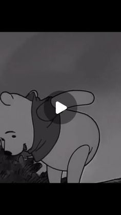 an animated image of a bear holding something in it's mouth while standing on top of a hill