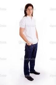 a young man standing with his hands in his pockets and looking at the camera while wearing glasses