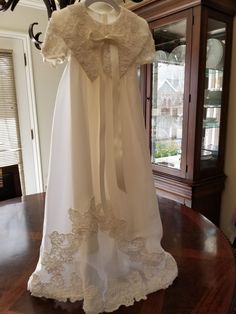 "FREE SHIPPING IN THE U.S. and reduced shipping rates for International orders. This beautiful gown is grandmother's wedding dress conversion, but it can be made new from similar fabric from my shop. Satin bodice with puffed sleeves and a scalloped lace edge. Organza skirt also has the scalloped lace edge. Beautiful large collar in the front with a bow (optional) Satin ribbon ties in the back of the waist. Bridal looping and satin buttons close the back. Matching bonnet included. Gown is made he Ceremony Floor-length Gown With Lace Trim, Floor-length Lace Trim Gown For Ceremony, Elegant Fitted Gown For Church, Elegant Baptism Gown With Fitted Bodice, Ceremony Baptism Dress With Lace Trim And Fitted Bodice, Baptism Dress With Fitted Bodice, Ball Gown Shape, Cream Baptism Dress With Fitted Bodice, Baptism Dresses With Fitted Bodice In Ball Gown Shape, Elegant Fitted Baptism Dress For Church