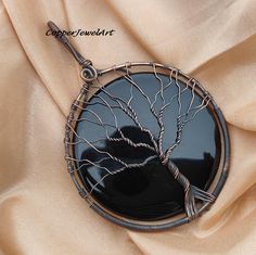 Tree of Life black onyx gemstone pendant ,Wire Wrapped Pendant, Anniversary pendant, lasted jewelry, copper jewelry ,Handmade pendant   stone -black onyx material- copper stone shape-round This is a classy fine hand- crafted sturdy- black onyx pendant. This pendant is made by combining wire. Everything in it is handmade. The stones are set properly so that the stones do not fall. It is so beautiful and the price is also right The pendant has oxide which enhances its beauty. These pendants are st Unique Black Copper Jewelry, Black Copper Pendant Jewelry, Hand Forged Black Jewelry As Gift, Black Hand Forged Jewelry For Gift, Hand Forged Black Jewelry Gift, Hand Forged Black Jewelry For Gift, Handmade Black Copper Necklaces, Handmade Black Copper Necklace, Black Copper Pendant Necklace