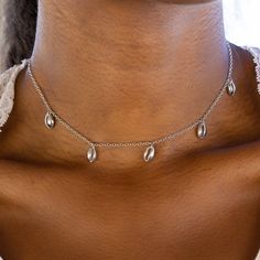 Description - The Next Piece To Add To Your Seashell Collection? Our Super-Cute Cowrie Choker! This Sleek Design Comes On A Delicate Silver Chain With Five Dangling Cowrie Shell Charms. It’s The Perfect Complement To Every Beach Day ‘Fit (Especially When You Pair It With The Cowrie Ring And Anklet!). Details - - Brass Base With Rhodium Plating - 14" With 2" Extension - Cowrie Shell Dimensions: 9mm (H) X 6mm (W) - 1.25" Between Shells Cute Necklace Pura Vida, Seashell Collection, Pura Vida Bracelets, Hang Ten, Cowrie Shell, Chain Anklet, Shell Pendant, Fashion Jewelry Necklaces, Beach Day