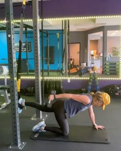 two people doing push ups in a gym