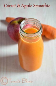 carrots and apple smoothie in a glass jar on a white table with an apple next to it