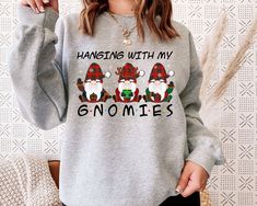 Get into the holiday spirit with our "Hanging With My Gnomies" sweatshirt! This cozy and funny gnome-themed Christmas hoodie is perfect for spreading festive cheer. Whether you're looking for a cute Santa sweatshirt or a unique Xmas holiday hoodie, this is the ultimate Christmas gift sweater for yourself or a loved one. Welcome to NIOBE BOUTIQUE. I am happy to see you in my shop. My main purpose is to meet you with a high-quality product. I use the best product to make you happy. Your satisfacti Holiday Hoodies, Santa Sweatshirt, Funny Christmas Sweaters, Gnome Christmas, Nurse Christmas, Holiday Sweatshirt, Sweatshirt Women, Holiday Humor, Sweater Gift