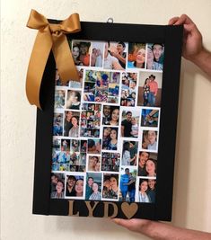 a person holding up a black frame with photos on it and a yellow ribbon around the edges