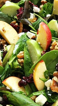 a salad with spinach, apples, walnuts and feta cheese