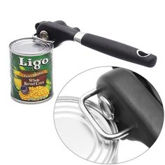 a can opener with a black handle next to a can of corn on the side