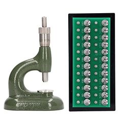 the microscope is next to a green board with silver screws and an electronic device