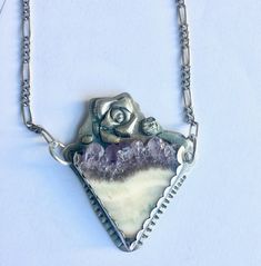 "another glorious stone in a piece by me. not sure what the ivory-yellow part of the stone is, but the top is amethyst crystal, and the combination of the colors is dreamy. my photos do not do the stone justice, but i've set it in 960 silver and attached a sterling chain to either side. a bit of texture, a bit of patina. height of pendant: 2\" width of pendant: 1 and 11/16\" length of pendant plus chain: just shy of 19 and 3/4\"" Collectible Amethyst Jewelry, Unique Purple Jewelry With Natural Stones, Artisan Amethyst Jewelry With Natural Stones, Artisan Jewelry With Natural Amethyst Stones, Purple Sterling Silver Necklace With Gemstone Accents, Sterling Silver Pendant Crystal Necklace With Stones, Amethyst Necklace With Large Pendant For Healing, Artisan Sterling Silver Purple Jewelry, Purple Artisan Sterling Silver Jewelry