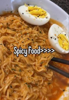 a bowl filled with noodles, hard boiled eggs and an egg yolk on top