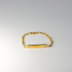 Introducing our elegant Real 14K Gold ID Bracelet with Figaro Link, a perfect fusion of modern style and timeless sophistication. Meticulously crafted, this bracelet is not just a piece of jewelry; it's a symbol of personal identity and enduring elegance. Your Unique Statement: Our Gold ID Bracelet offers a personalized touch with an engraved ID tag, allowing you to carry a name or message that holds special meaning to you. The Figaro Link design adds a contemporary flair to this classic piece. Personal Identity, Link Design, Bar Bracelet, Id Bracelets, Bar Bracelets, Heartfelt Gifts, Id Tag, Chain Link Bracelet, Diamond Cut