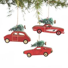 three red cars with christmas trees on them hanging from a pine tree ornament