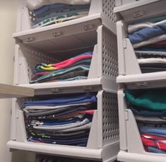 an organized closet with clothes and t - shirts in it's bins for storage