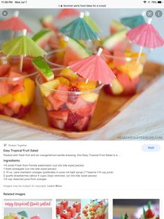 a website page with an image of fruit salad in cups and umbrellas on top