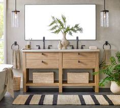 a bathroom with two sinks and a large mirror over it's vanity area, along with a rug on the floor