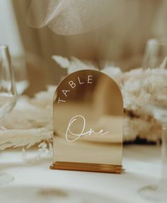 a place card holder with the word table one written on it