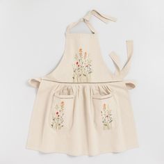 an apron with embroidered flowers on it