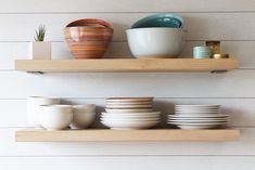 two wooden shelves with plates and bowls on them, one has a speech bubble above it