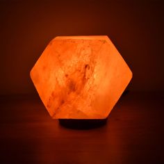 an orange light sitting on top of a wooden table