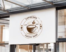 a coffee shop sign hanging from the side of a building