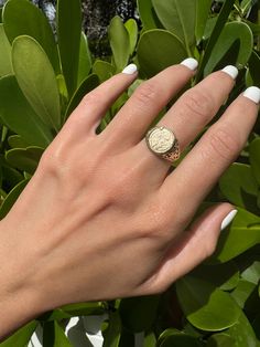 Vintage 9k Coin Signet Ring Ornate Shoulders Description: This vintage 9k coin signet ring features ornate shoulders, adding a unique touch to your collection. Sized at 6 and weighing 2.44g, the coin measures 11.8mm and showcases British hallmarks. This piece is perfect for adding a statement to any outfit. As with all our pieces, this ring is a rare find--once it's gone, it's gone. Choosing this piece helps you stand out from the crowd while supporting sustainable practices. Why You'll Love It:      Unique Design: The ornate shoulders and coin add a distinct, stylish element.      Perfect for Stacking: The design makes it versatile for stacking with other rings.      Dainty and Slim: The delicate design is ideal for a chic, minimalist look.      Rare and Exclusive: Stand out from the rest Elegant Engraved Coin Rings, Gold Coin-shaped Engraved Signet Ring, Gold Engraved Coin Signet Ring, Heirloom Coin Shaped Hallmarked Rings, Yellow Gold Coin-shaped Hallmarked Rings, Vintage 14k Gold Coin Ring, 14k Gold Coin-shaped Rings, 14k Stamped Yellow Gold Coin Ring, 14k Gold Coin Shaped Anniversary Rings