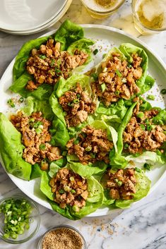 lettuce wraps filled with meat and seasoning on a plate