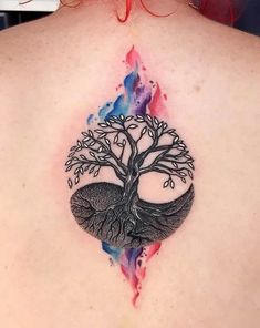 a woman's back with a tree tattoo on it