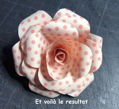 a paper flower with polka dots on it