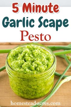 a jar filled with pesto sitting on top of a wooden table