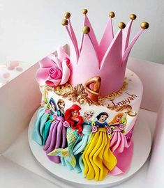 there is a cake decorated with princesses on it