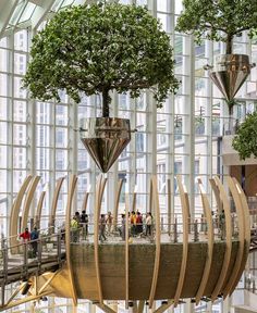 the inside of a building with many trees in it