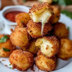 some fried food on a white plate with sauce and parmesan cheese being drizzled over it