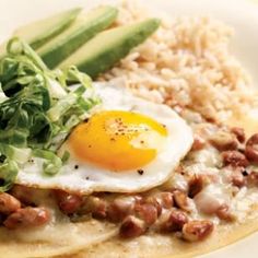 a plate with rice, beans and an egg on it