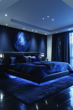 a large bed sitting in the middle of a bedroom next to a blue curtained window