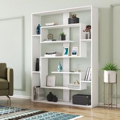 a living room with a couch, chair and bookshelf on the wall in front of it