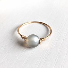 "This beautifully simple ring is lovingly handmade with a Moonstone and a choice of 14k Gold Filled, 14k Rose Gold Filled or Sterling Silver band. M A T E R I A L S: * Grey Moonstone * 14k Gold Filled, 14k Rose Gold Filled or Sterling Silver S I Z E: *  Gemstone - Approximately 6mm *  Band Thickness - Approximately 0.8-1mm  All of our jewellery is carefully handmade using good quality materials and handpicked gemstones, with the aim to produce quality pieces that you can love & wear for years to come.  M O O N S T O N E: * June Birthstone * Talisman for Cancer, Libra & Scorpio * Third Eye Chakra, Solar Plexus Chakra A stone for \"new beginnings\", Moonstone is a stone of inner growth and strength.  It soothes emotional instability and stress, and stabilises the emotions, providing calmness Adjustable Round Moonstone Ring In Minimalist Style, Adjustable Yellow Gold Moonstone Ring For Everyday, Adjustable Minimalist Yellow Gold Moonstone Ring, Adjustable 14k Gold Moonstone Ring For Everyday, Adjustable Minimalist Moonstone Ring As Gift, Minimalist Adjustable Moonstone Ring As Gift, Minimalist Adjustable Moonstone Ring For Gift, Adjustable Hand Wrapped Moonstone Ring, Adjustable 14k Gold Minimalist Moonstone Ring