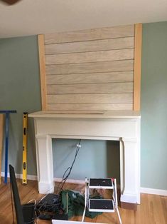 the fireplace is being built and ready to be installed in the living room with tools on the floor