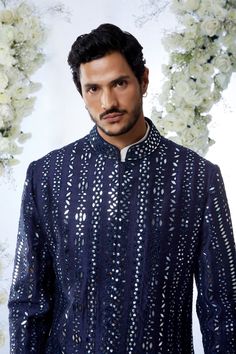 This midnight sherwani set features all over mirror work on a raw silk base. It is paired with an off-white cotton kurta and a afghani cotton silk salwar. Completing footwear is also available.From Seema Gujral's Tuscan Summer collection. DELIVERY TIMEPlease allow 4 months for your outfit to arrive.FABRIC DETAILSRaw SilkProfessional cleaning only. Tuscan Summer, Seema Gujral, Lakshmi Images, Vogue India, Blue Mirror, Cotton Kurta, Blue Mirrors, Mirror Work, Garment Bags