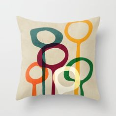 a pillow with an abstract design on the front and back, featuring circles in different colors