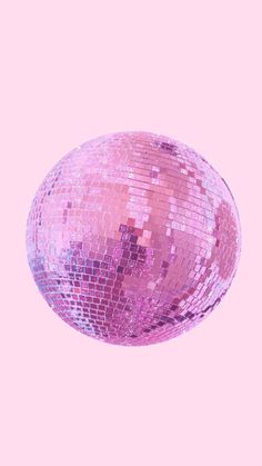 a shiny pink disco ball on a pink background