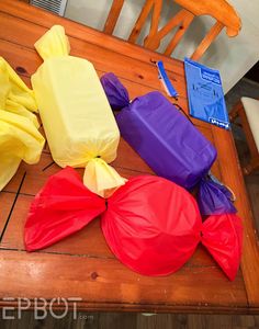 colorful bags sitting on top of a wooden table