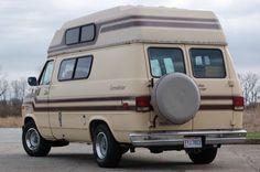 an old camper van parked on the side of the road