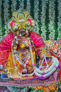 an idol is displayed in front of some flowers