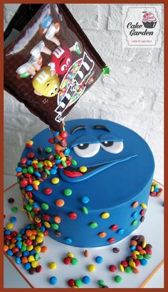 a blue cake with candy and candies on top is being blown by the wind