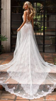 a woman in a wedding dress is standing on the steps with her back to the camera