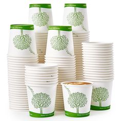 a stack of white cups with green trees on them