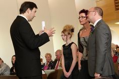 two men and one woman standing in front of an audience